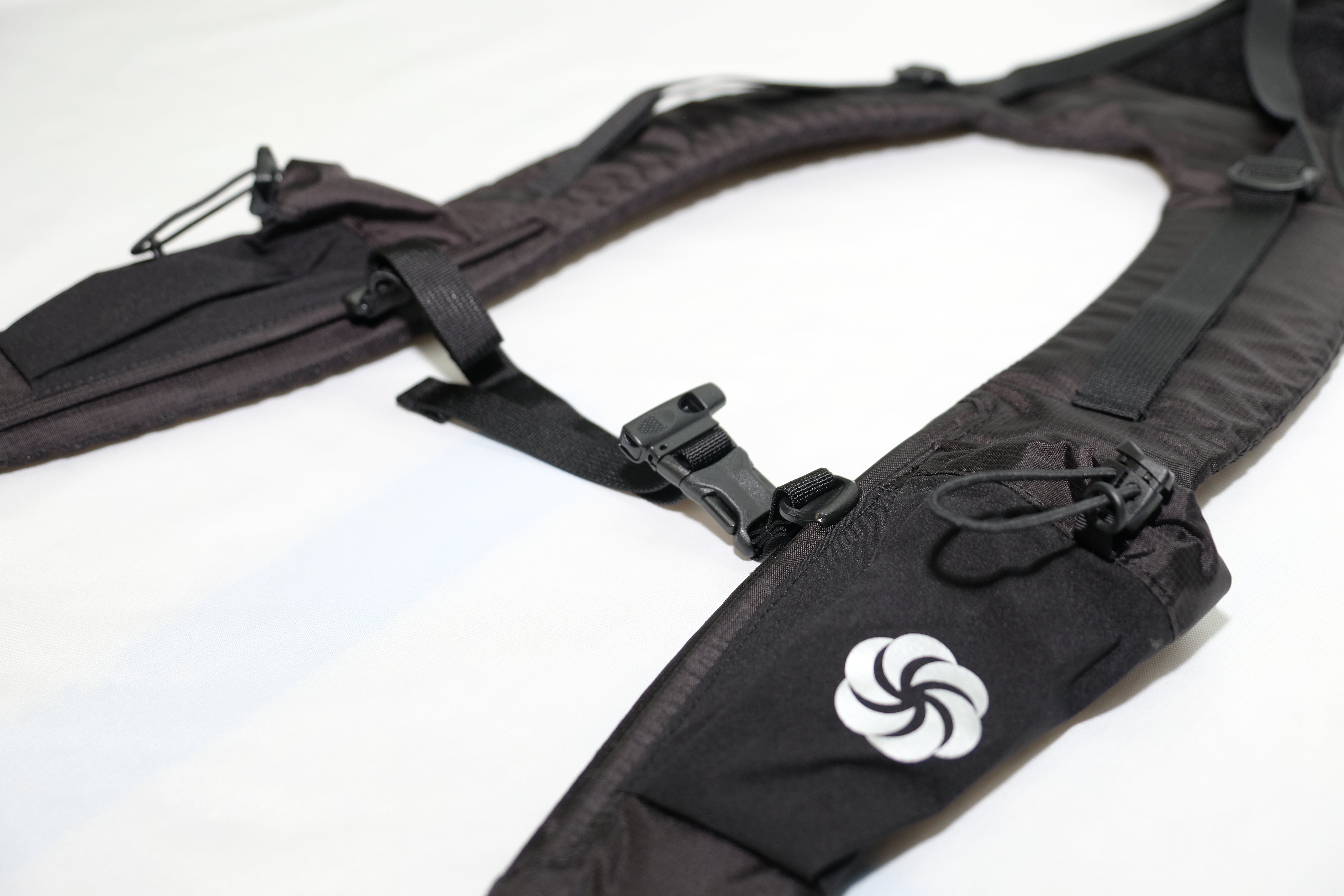 Close up of the Side pocket and the sternum strap on the Shoulder Strap on a white background.