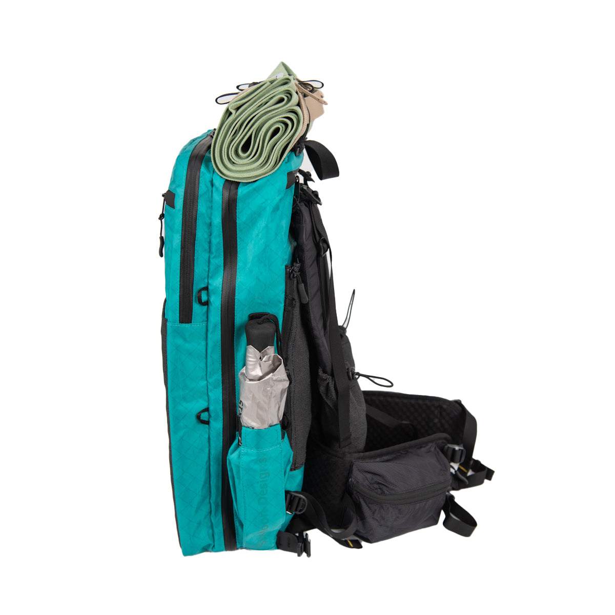 SMD ADC Plus Teal right side also showing shoulder straps and hip. Silver Shadow mini umbrella in the pocket and a towel strapped on top belt on a white background
