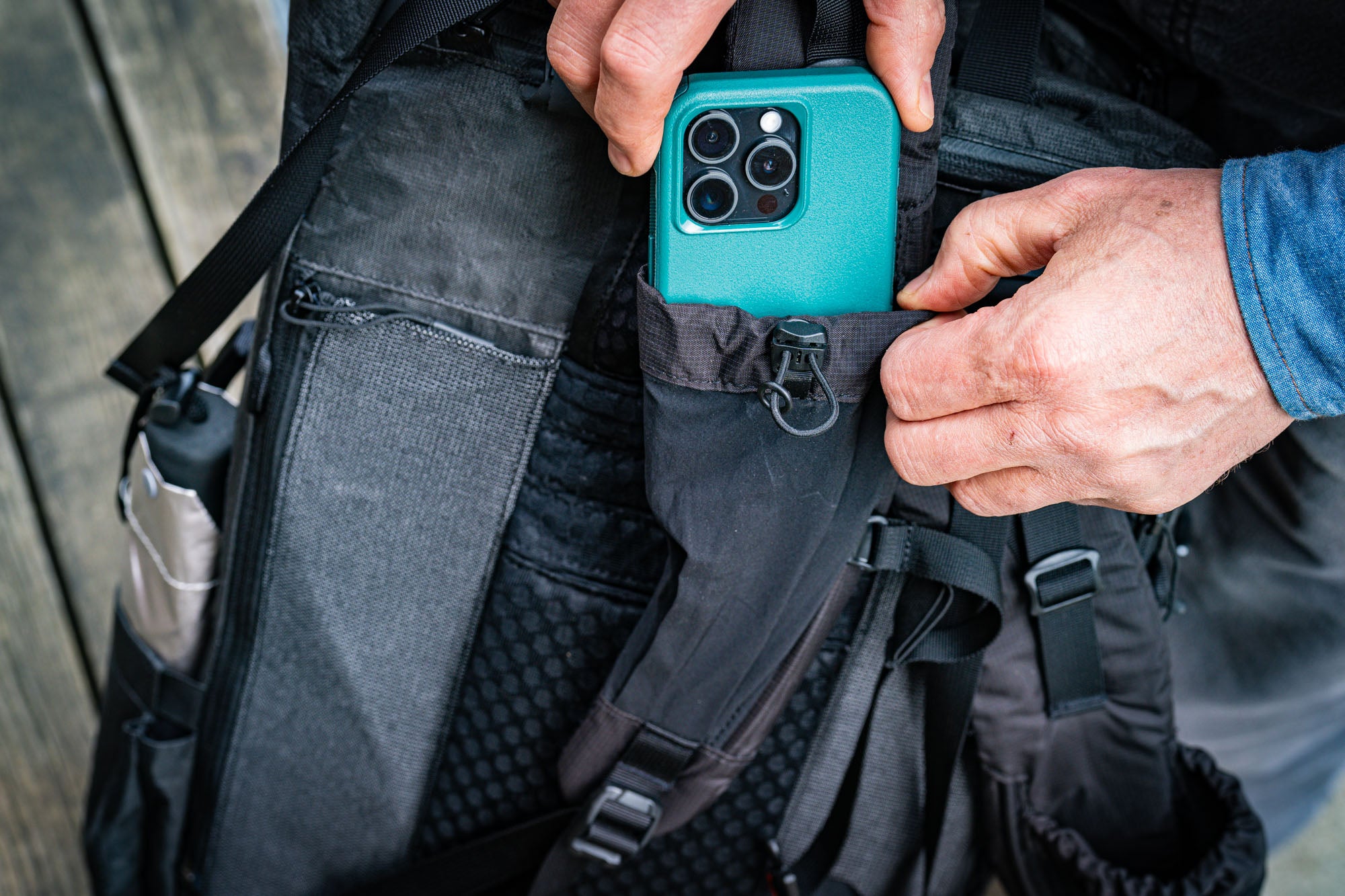 Putting a cell phone into the ADC Shoulder strap. 