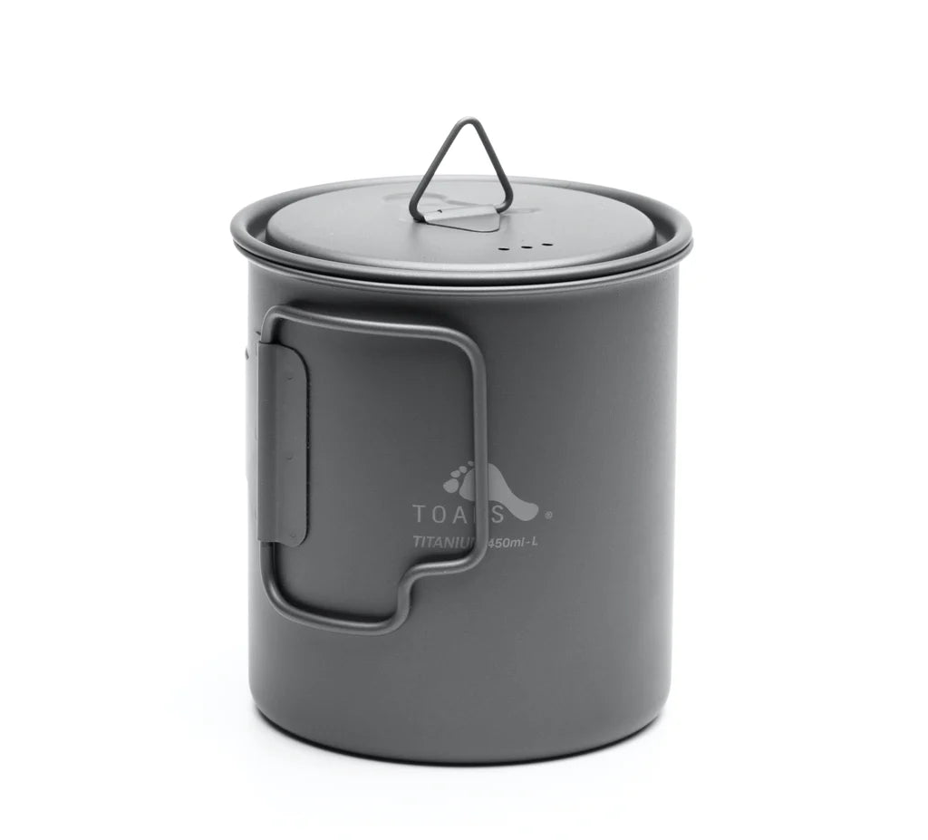 Toaks 450ml cup standing up with the lid on top and the handle folded in on a white background