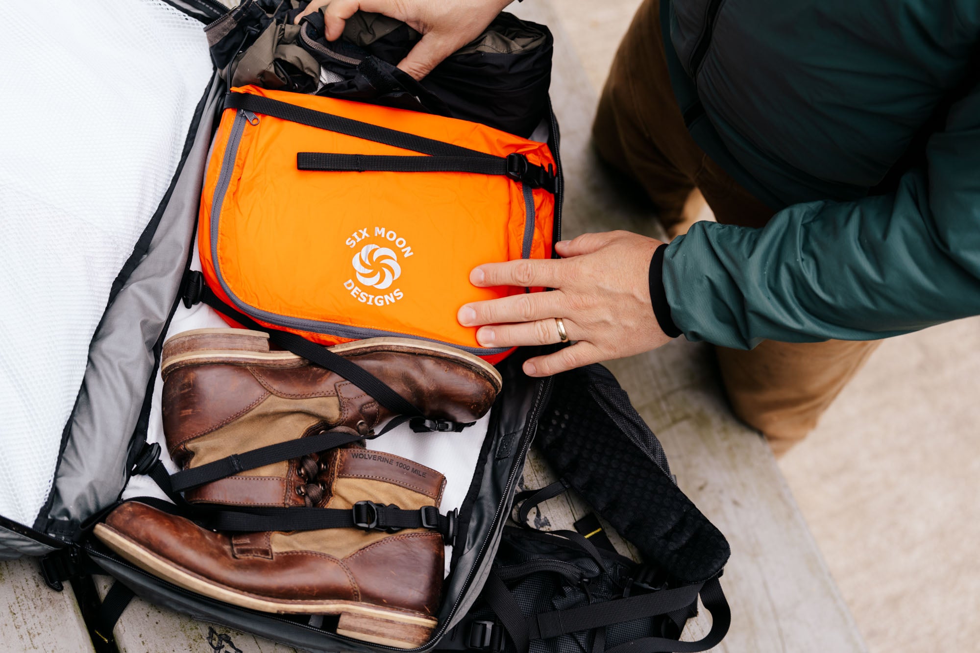 Accessories within an ADC backpack.  Orange Packing Pod and a pair of Boots.  
