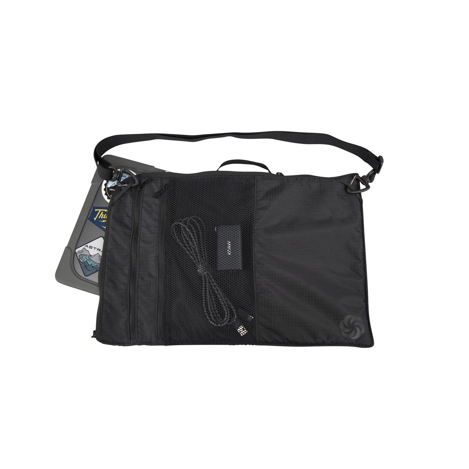 Black Laptop Sleeve with a strap on a white background with the Six Moon Designs Logo.   A Laptop is sticking out of the main pocket and the front mesh pocket is holding a charging cable.  